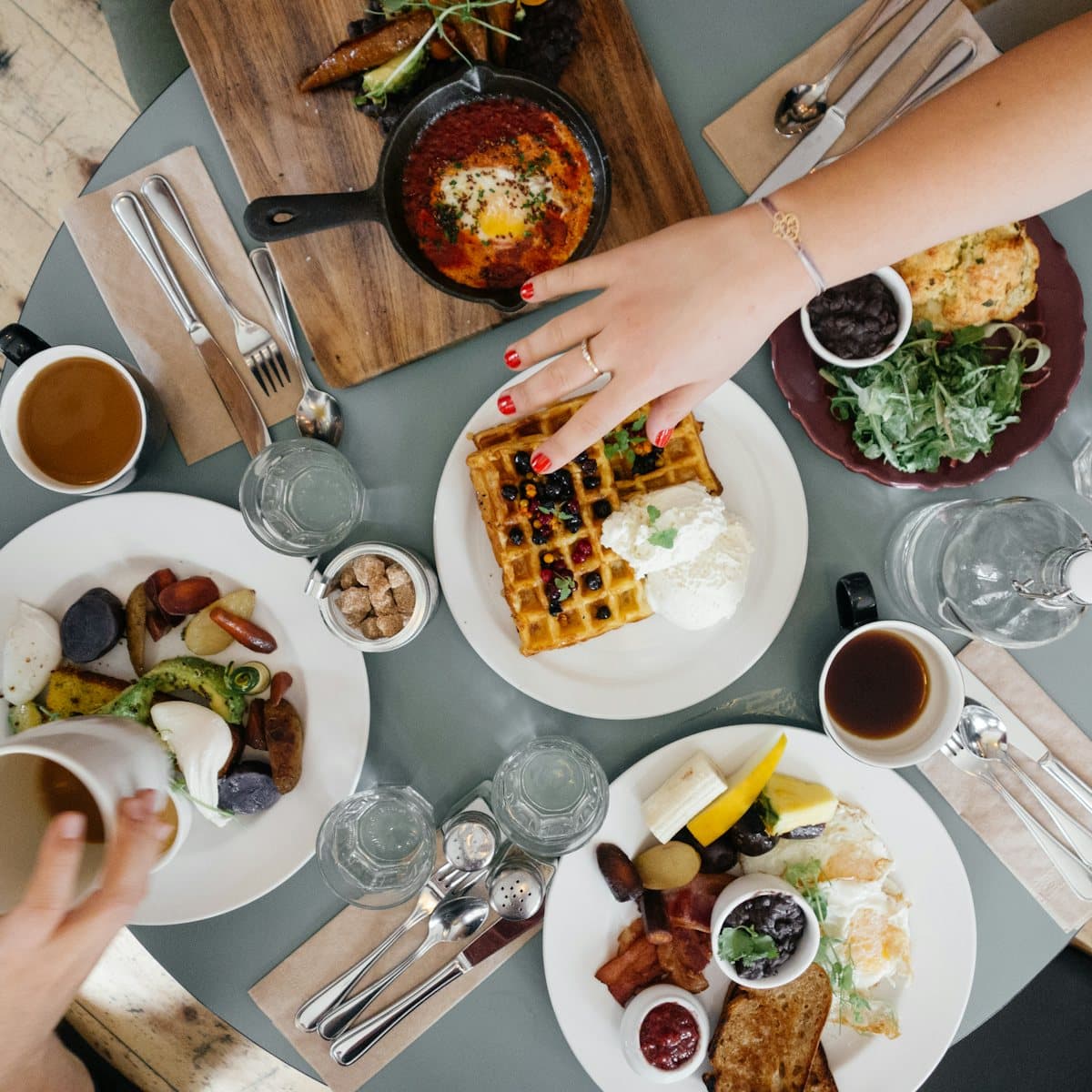 A shared table laid for breakfast, seen from above